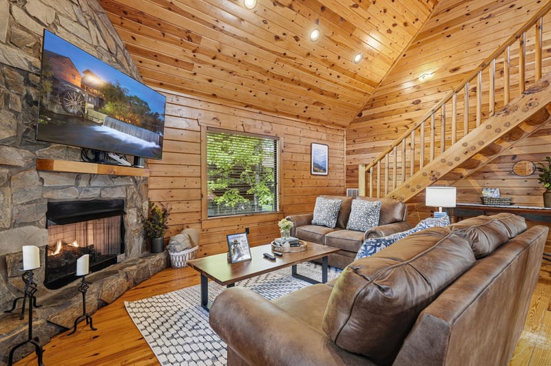 Sink into plush leather seating by your crackling fireplace, where rustic wood beams create the perfect cozy atmosphere for memorable evenings.
