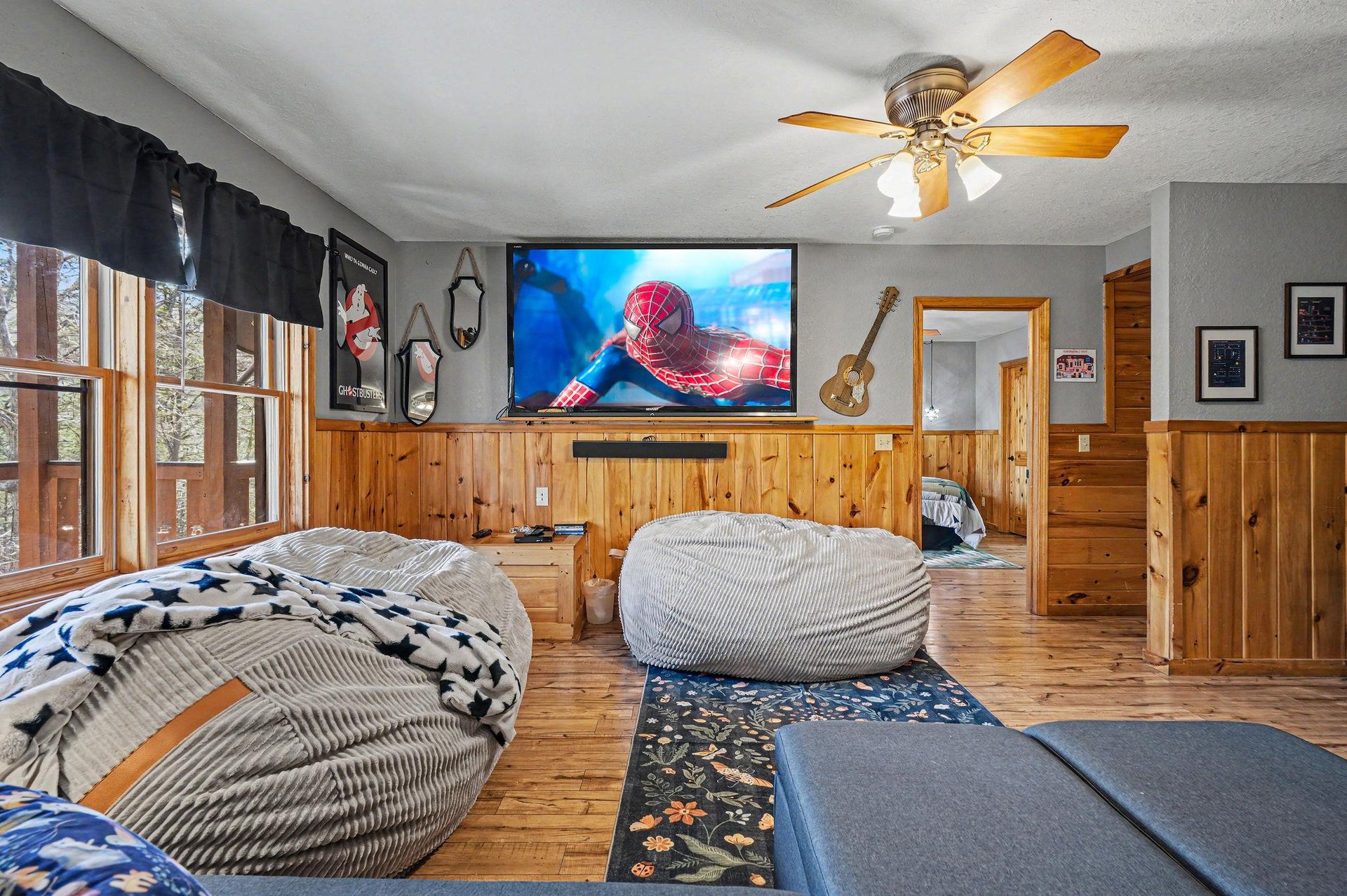 Settle into plush bean bags for movie nights on the big screen in this cozy entertainment loft.