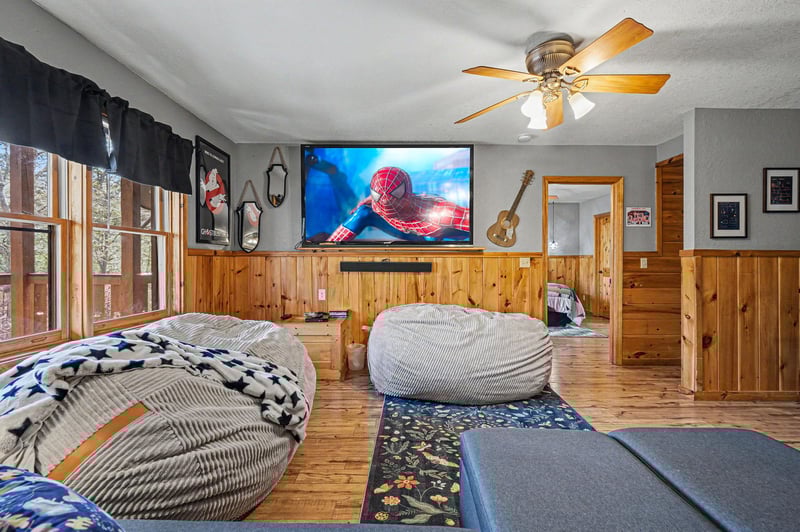 Settle into plush bean bags for movie nights on the big screen in this cozy entertainment loft.