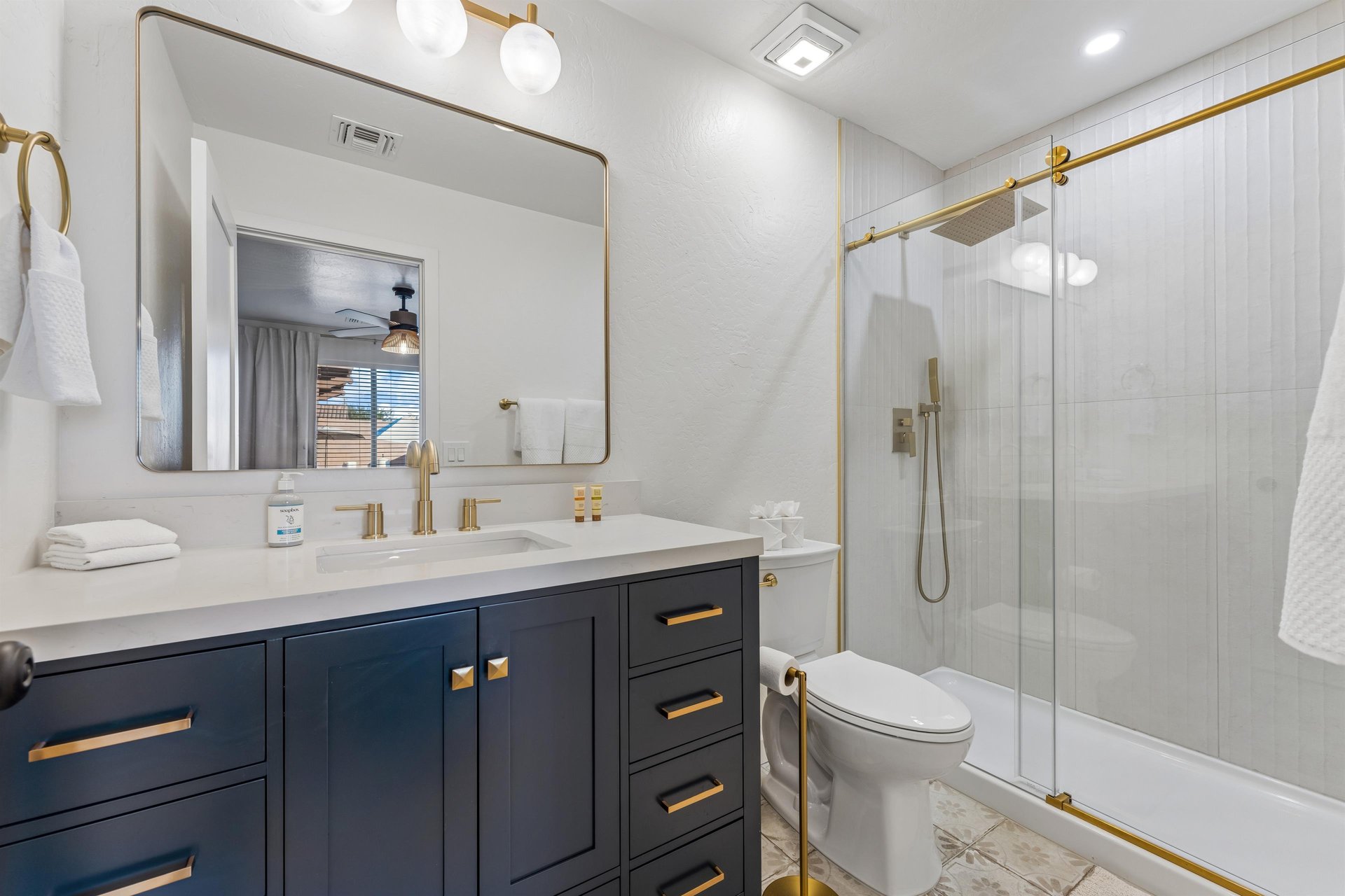 Standalone shower and modern fixtures.