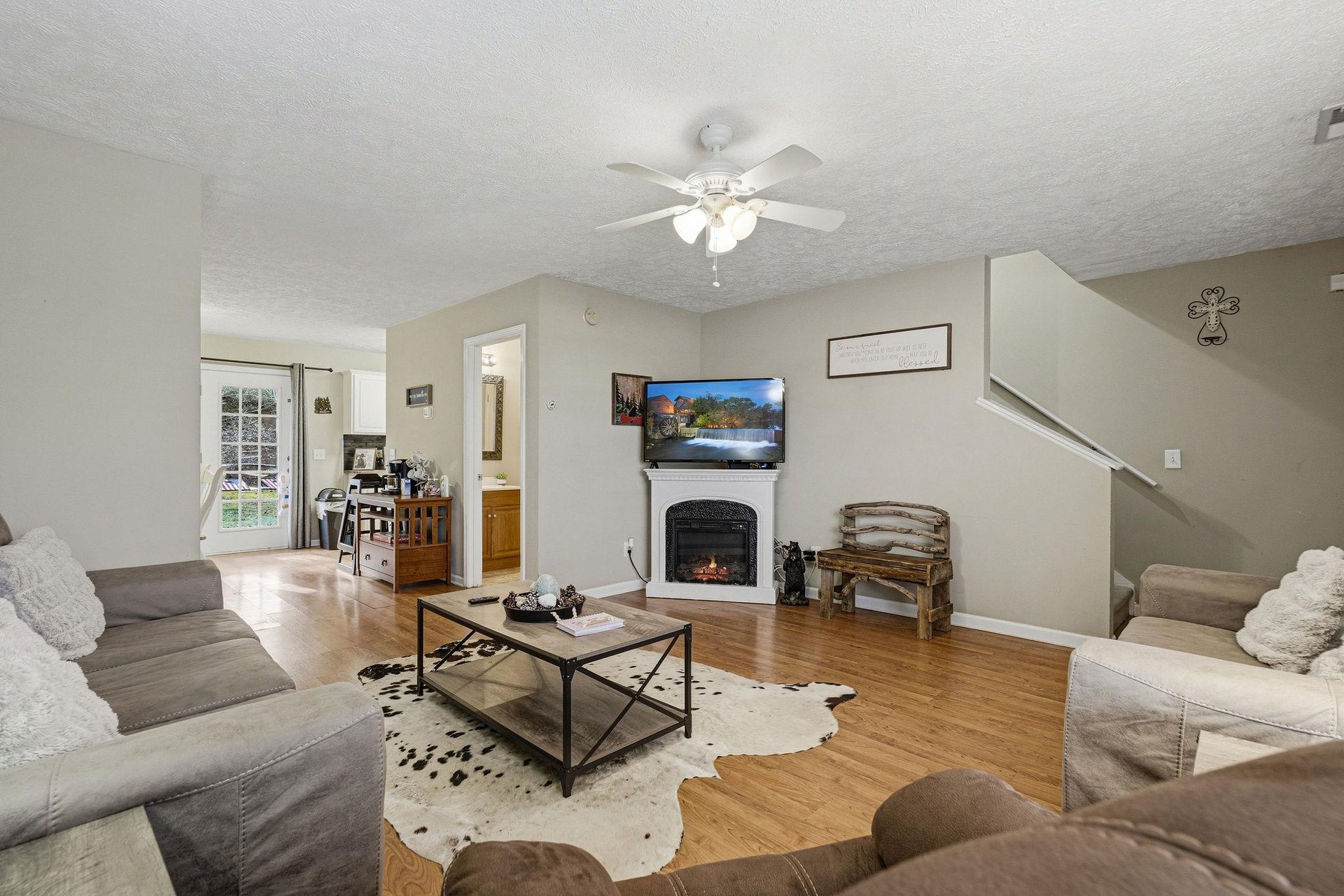 Unwind in your cozy living space with plush seating, warm fireplace, and smart TV for perfect evening relaxation.