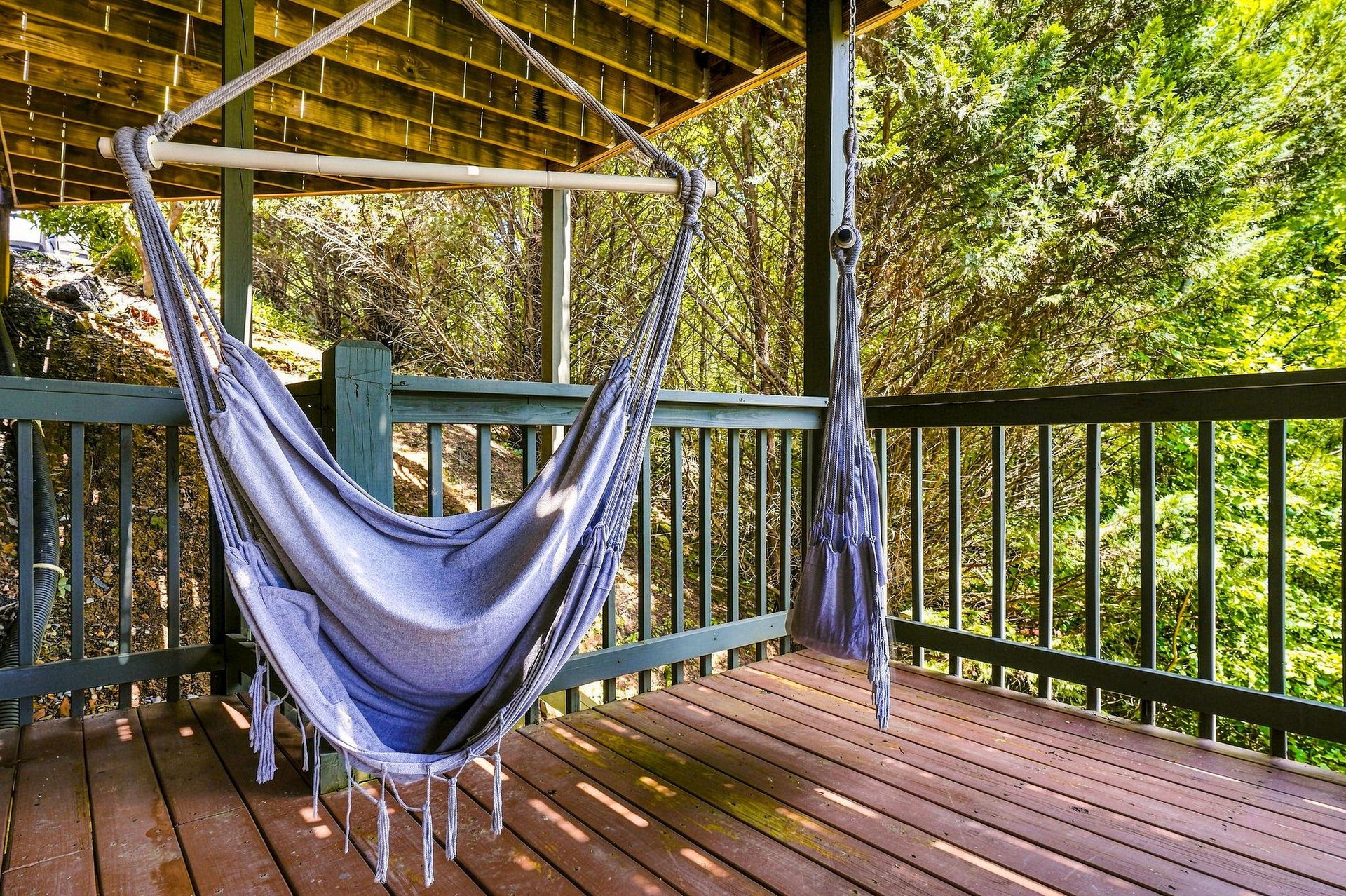 Settle into this hammock swing on your private deck and lose yourself in the lush forest views—a perfect spot for morning coffee or peaceful afternoon reading.