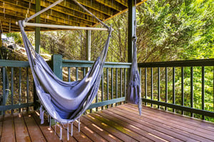 Settle into this hammock swing on your private deck and lose yourself in the lush forest views—a perfect spot for morning coffee or peaceful afternoon reading.