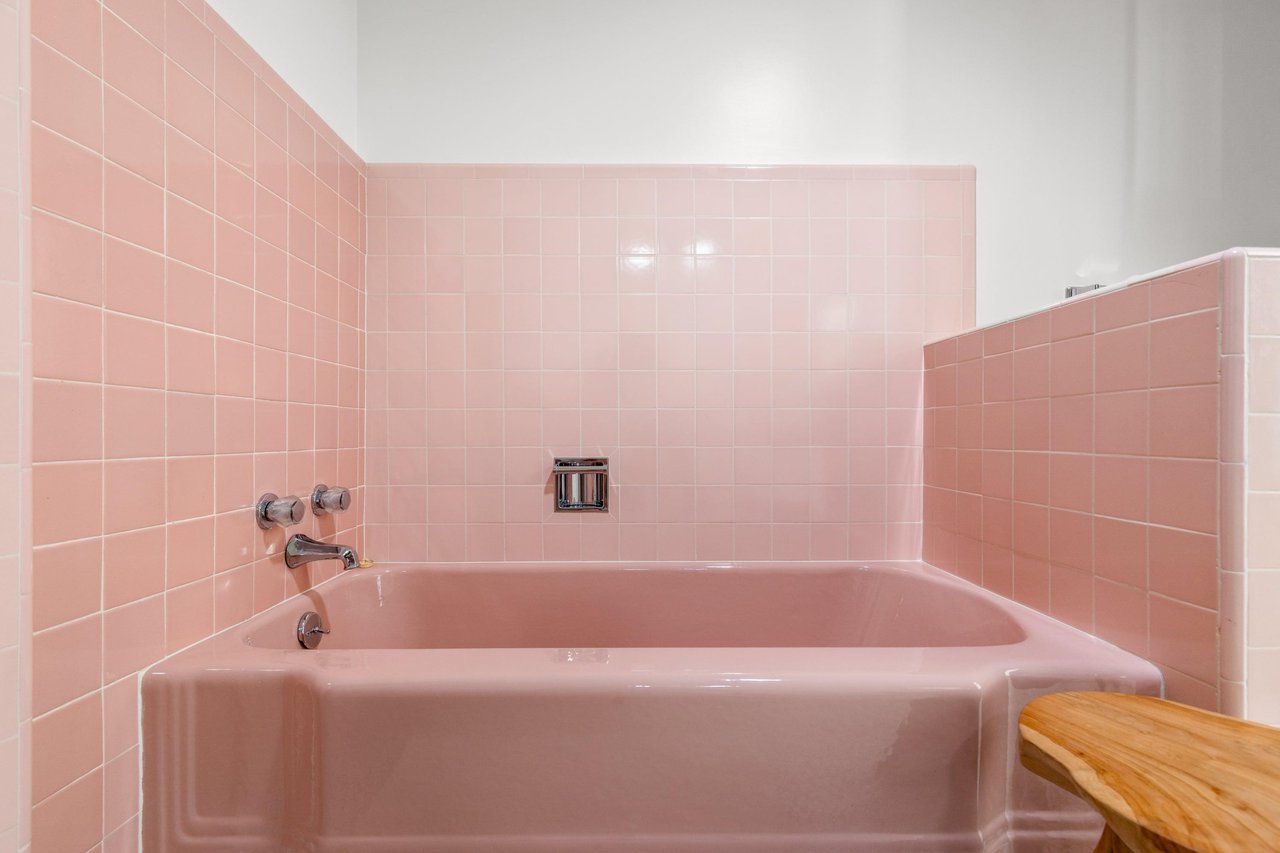 Ensuite bathroom with standalone shower, tub, and beautiful pink tile