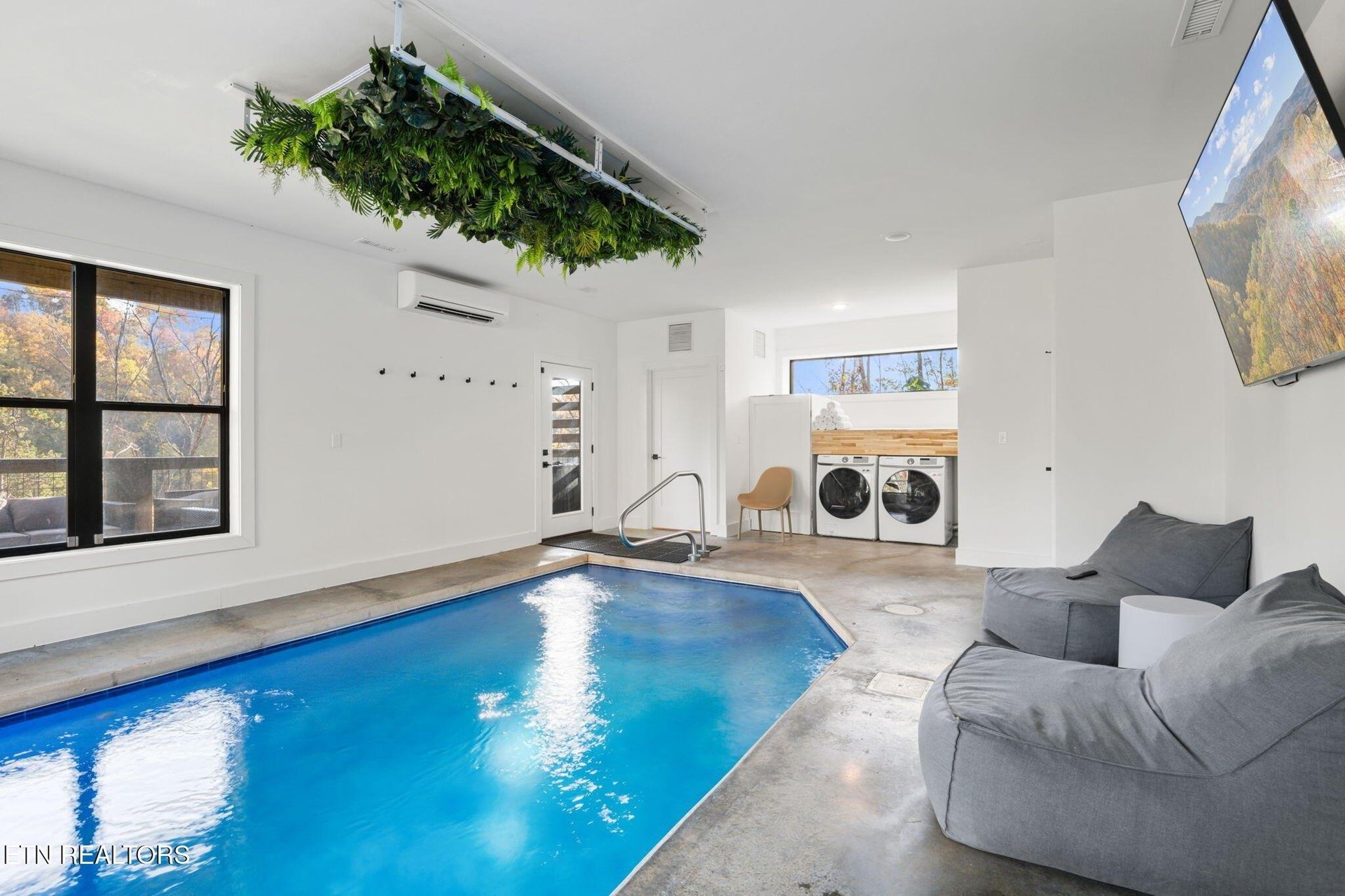 Your own private indoor pool awaits—perfect for a morning swim or unwinding after a day of adventure. The space feels bright and open, with autumn views framing the experience.