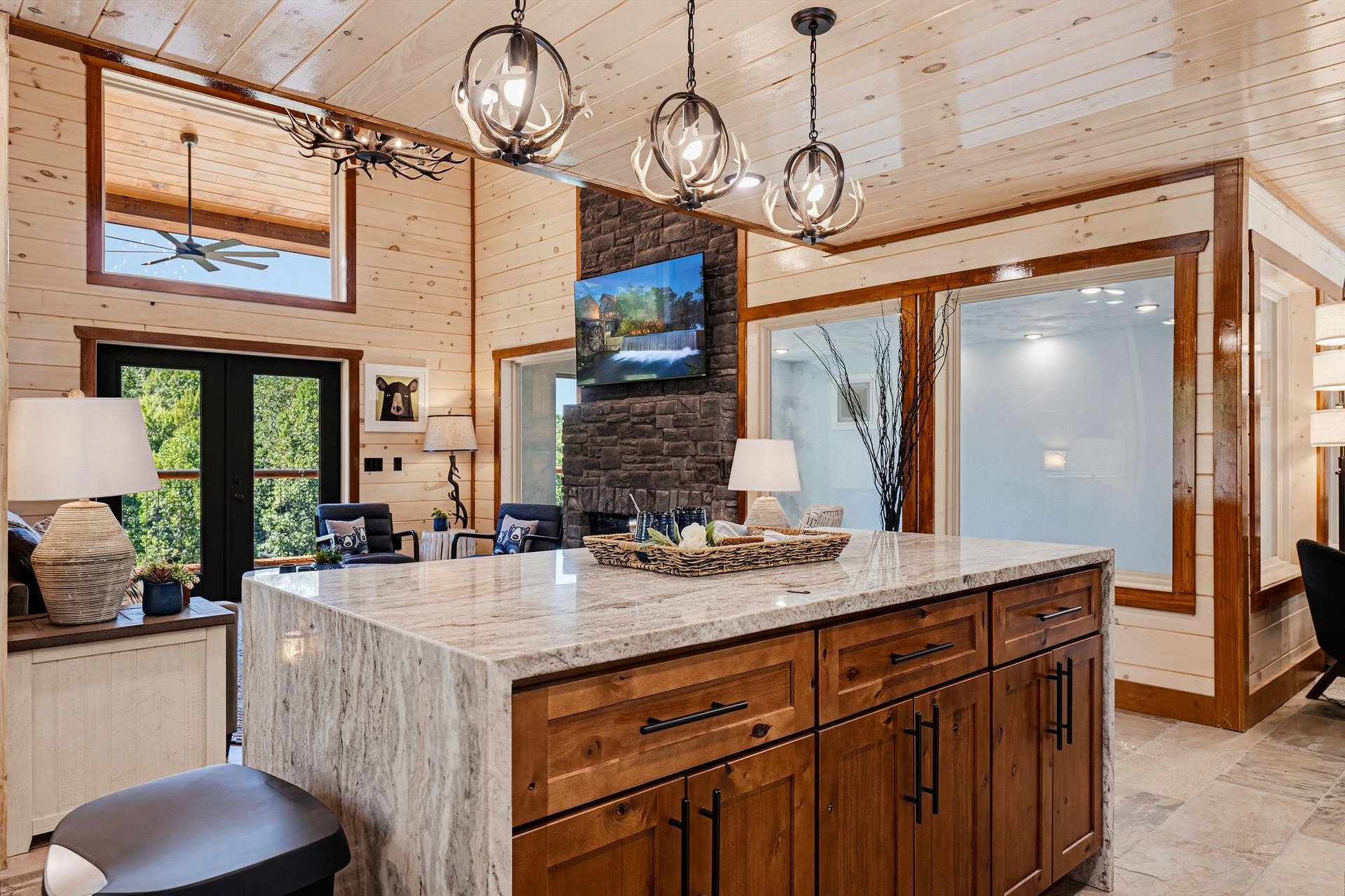 Your gourmet kitchen features a stunning granite island, rustic wood cabinetry, and elegant pendant lighting—perfect for gathering and creating memorable meals together.