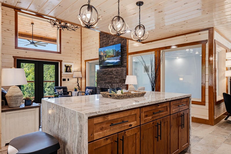 Your gourmet kitchen features a stunning granite island, rustic wood cabinetry, and elegant pendant lighting—perfect for gathering and creating memorable meals together.