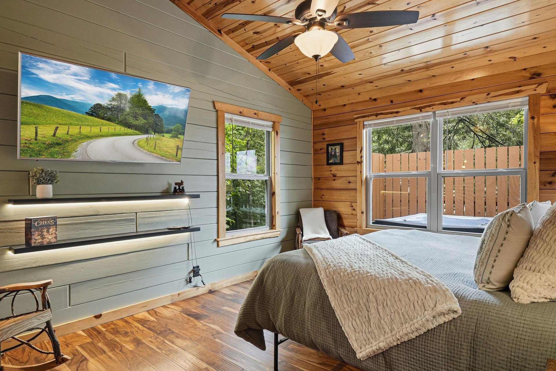 Your private retreat features natural wood ceilings and large sliding doors opening to a quiet outdoor deck, perfect for morning coffee or evening relaxation.