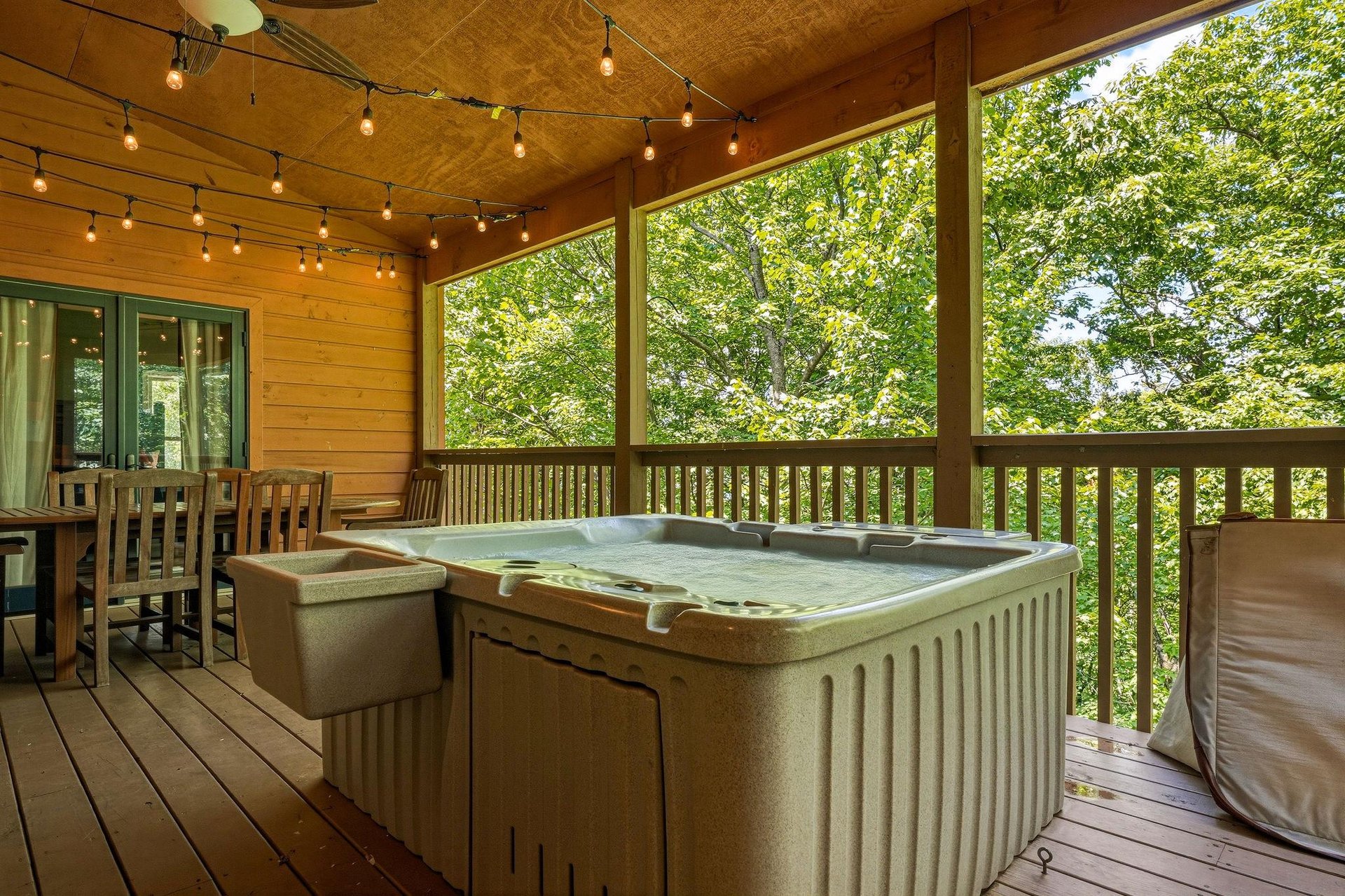 Unwind in your private hot tub on the covered deck, surrounded by lush forest views and twinkling string lights overhead. Perfect for soaking under the stars after a day of adventure.