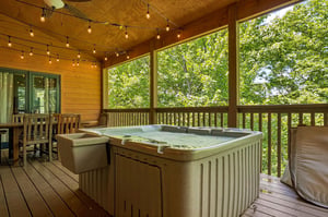 Unwind in your private hot tub on the covered deck, surrounded by lush forest views and twinkling string lights overhead. Perfect for soaking under the stars after a day of adventure.