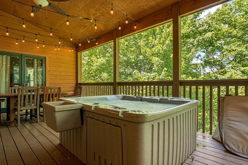 Unwind in your private hot tub on the covered deck, surrounded by lush forest views and twinkling string lights overhead. Perfect for soaking under the stars after a day of adventure.