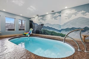 Dive into your private mountain oasis, where crystalclear waters await beneath a stunning wilderness mural.