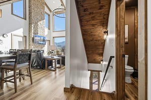 Relax in your stunning alpine retreat with soaring ceilings, exposed wood beams, and panoramic mountain views through floortoceiling windows.