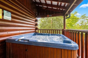 Slip into your private hot tub and let the warm, bubbling water melt away the day as you gaze out at the lush forest views from your covered deck.