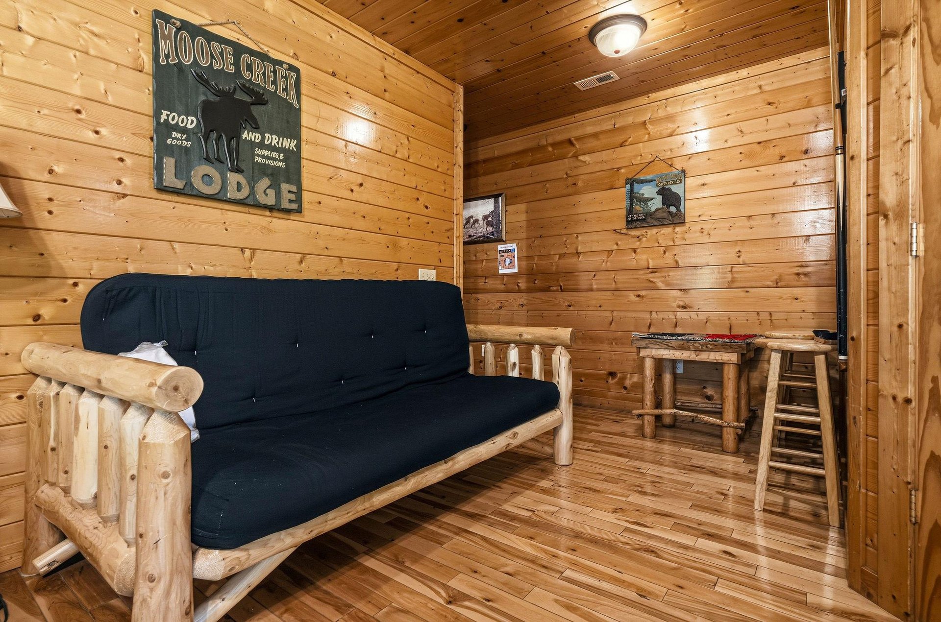 Unwind in your cozy cabin retreat with rustic log furnishings, warm pine walls, and a relaxed lodge atmosphere—perfect for quiet evenings after exploring the outdoors.