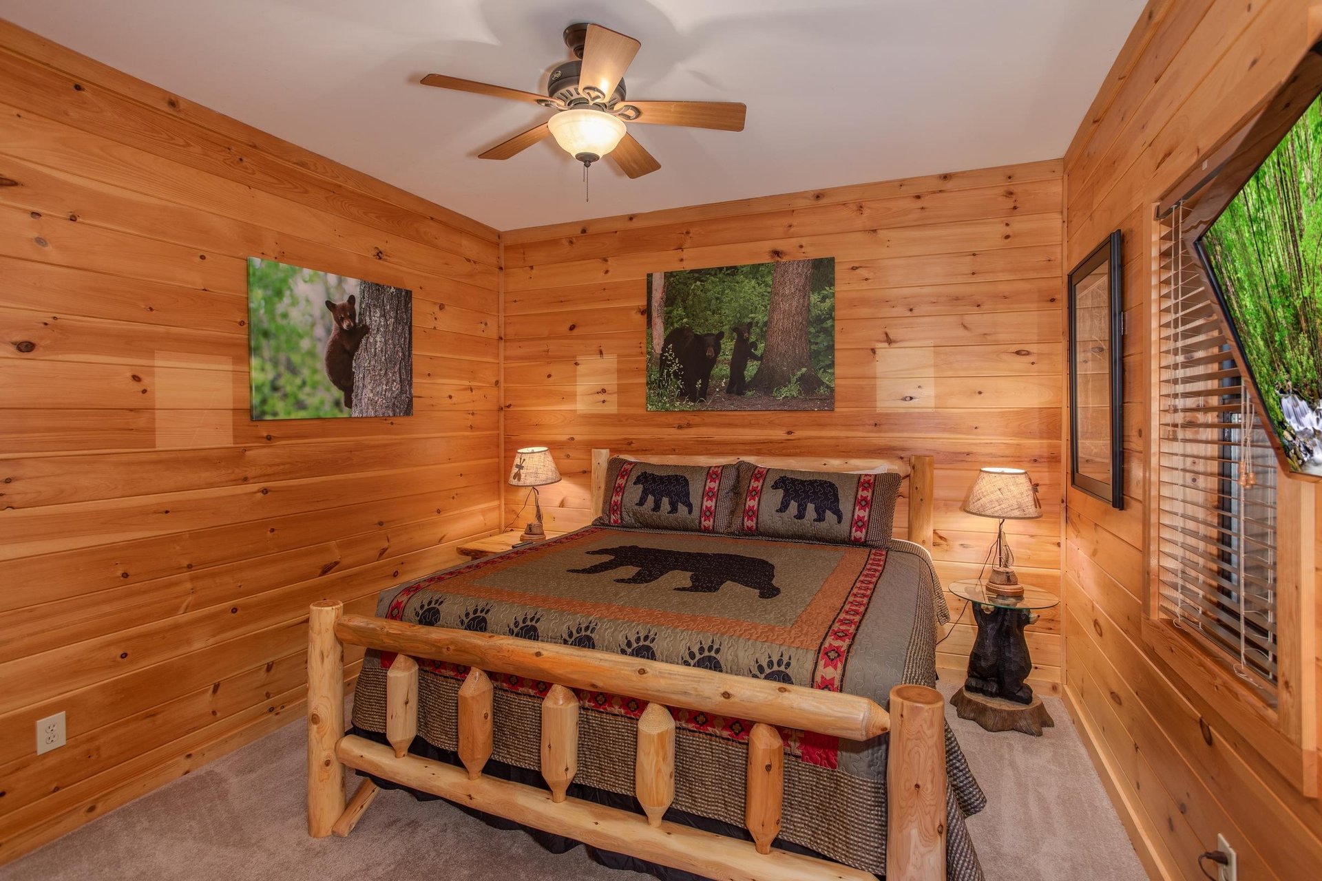 Kingsized log bed and two end tables at Great View Lodge, a 5bedroom cabin rental located in Pigeon Forge