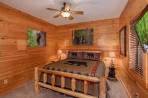 Kingsized log bed and two end tables at Great View Lodge, a 5bedroom cabin rental located in Pigeon Forge