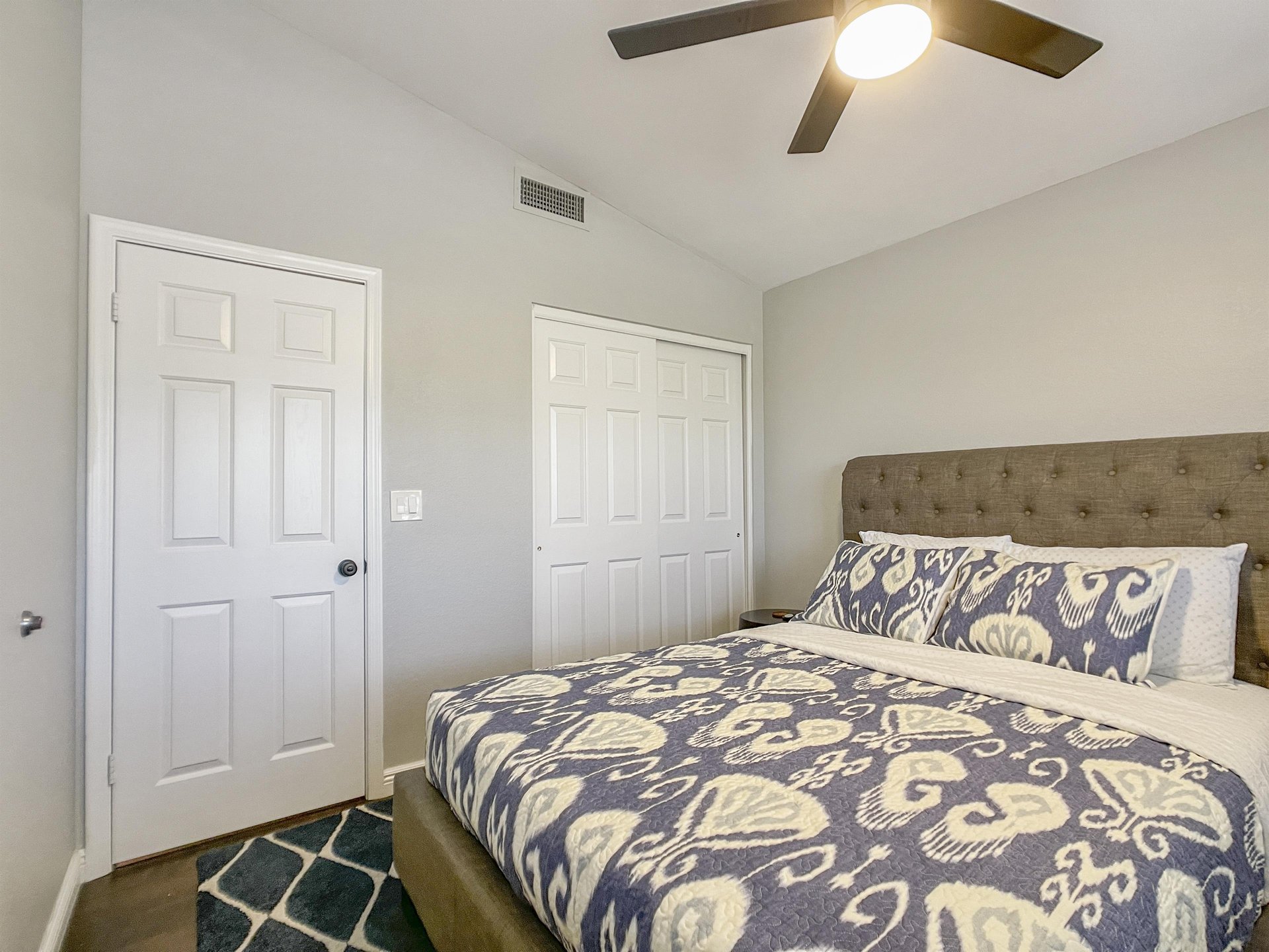 Queen bed in the one of three bedrooms in the home