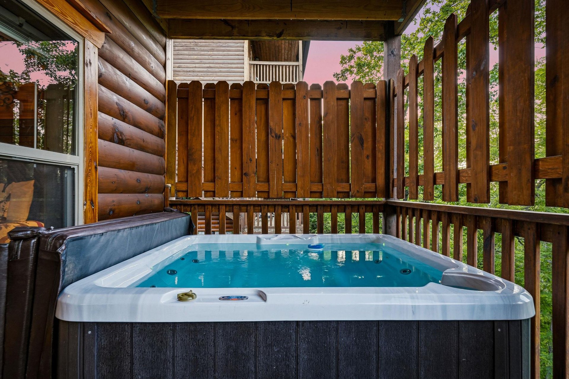 Slip into your private hot tub surrounded by natural wood and forest views for the ultimate relaxation retreat.