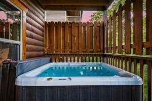Slip into your private hot tub surrounded by natural wood and forest views for the ultimate relaxation retreat.
