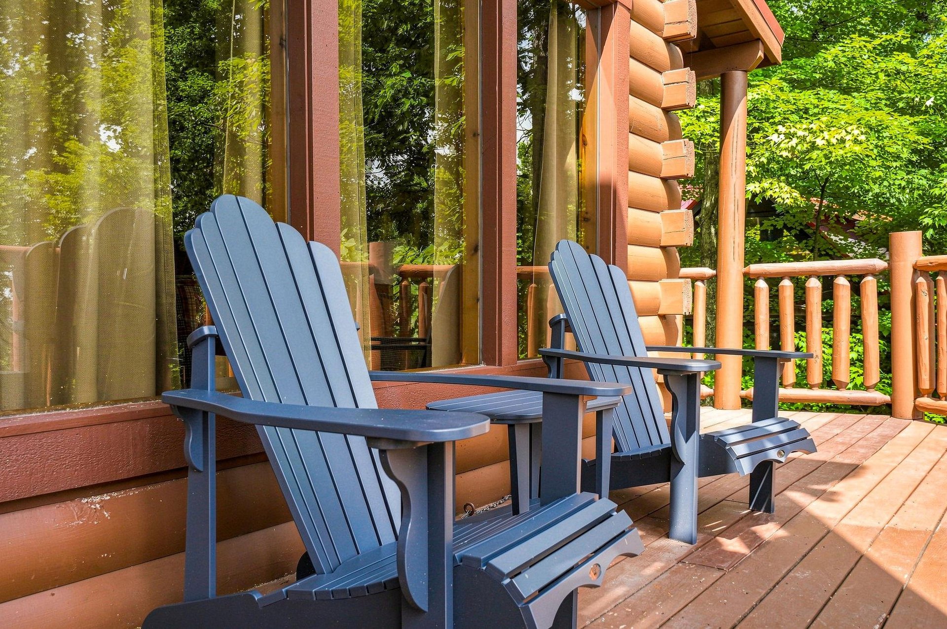 Step onto your private deck and sink into an Adirondack chair, surrounded by lush greenery and the peaceful sounds of nature—your serene woodland retreat awaits.