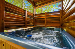 Slip into your private hot tub sanctuary, where bubbling waters and natural wood create your perfect outdoor retreat.