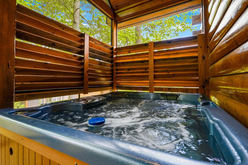 Slip into your private hot tub sanctuary, where bubbling waters and natural wood create your perfect outdoor retreat.