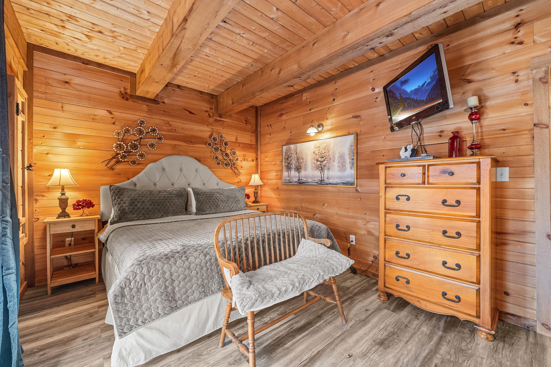 Bedroom with dresser and flat screen at Living on Love, a 2 bedroom cabin rental located in Pigeon Forge