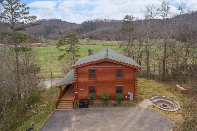 Ariel View of Cabin and fire pit with the meadow nearby