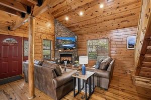 Sink into plush leather seating by your crackling stone fireplace, surrounded by warm wood walls that make every evening feel like a mountain retreat.