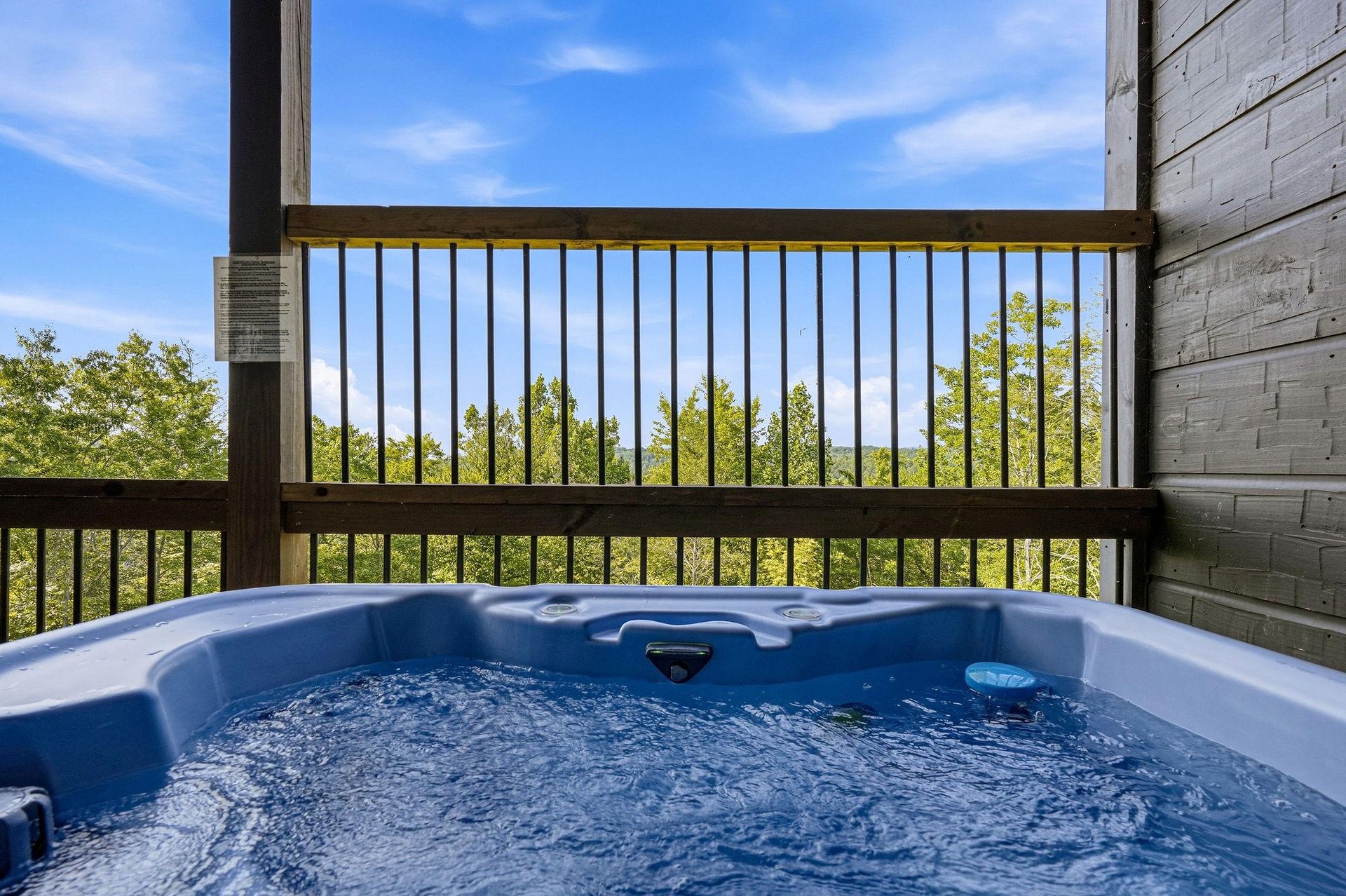 Sink into the bubbling hot tub on your private deck, where treetop views and open sky create your own peaceful escape.