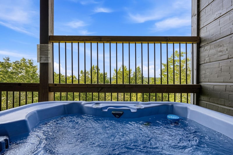 Sink into the bubbling hot tub on your private deck, where treetop views and open sky create your own peaceful escape.