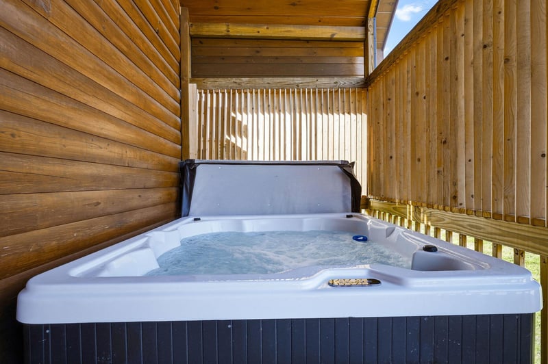 Unwind in your private hot tub surrounded by warm wood walls, where bubbling jets and mountain air create your perfect retreat.