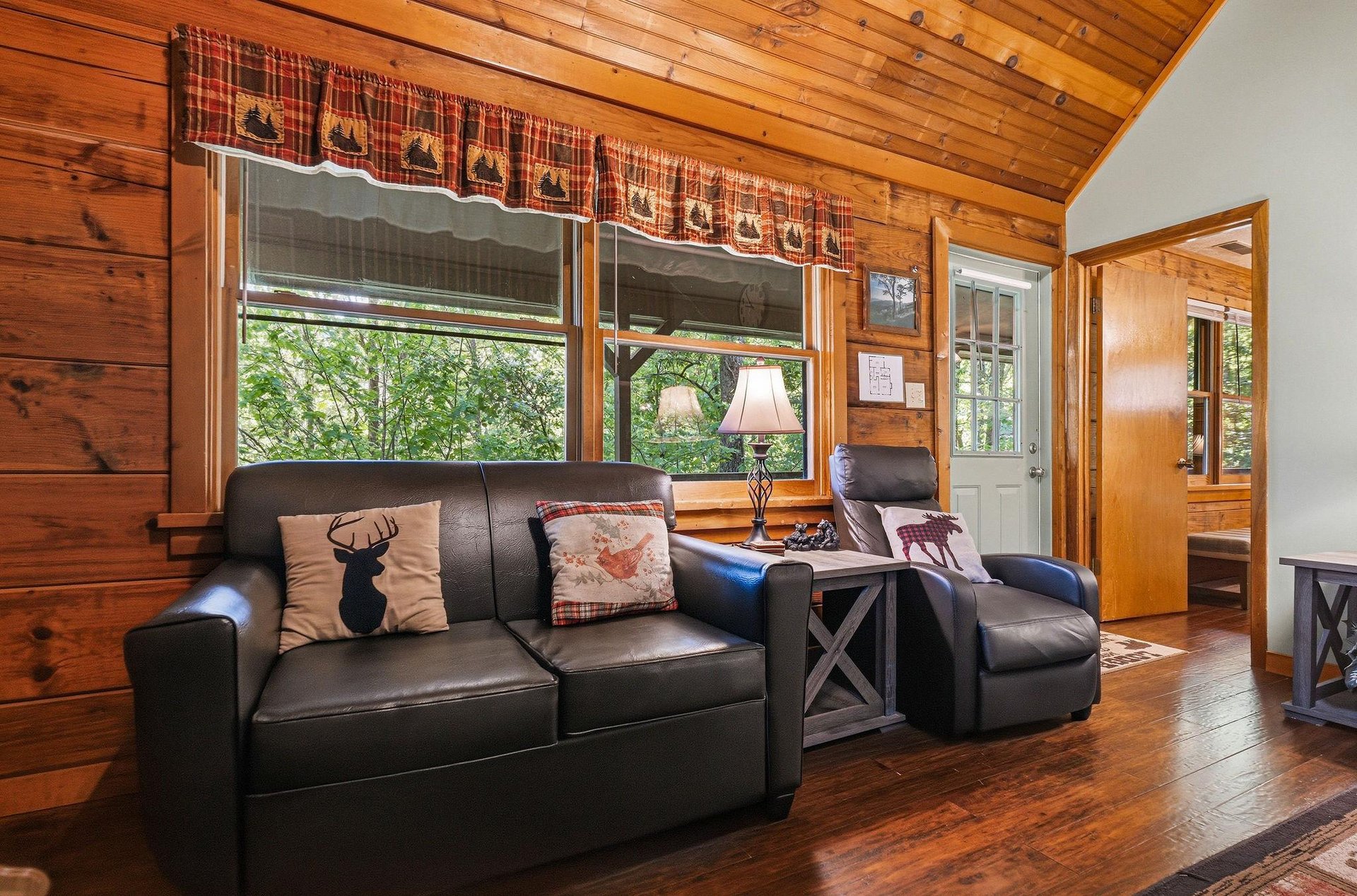 Sink into plush leather seating surrounded by warm wood walls and charming woodland views through your windows.