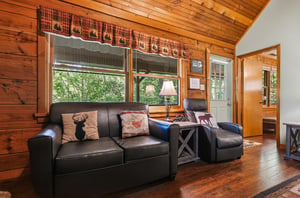 Sink into plush leather seating surrounded by warm wood walls and charming woodland views through your windows.