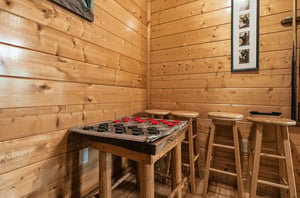 Challenge friends to a game of checkers in this cozy corner, where rustic wood and classic board games create the perfect setting for your vacation fun.