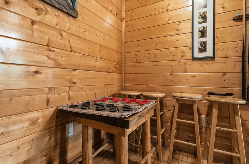 Challenge friends to a game of checkers in this cozy corner, where rustic wood and classic board games create the perfect setting for your vacation fun.