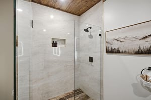 Step into your private spalike shower with beautiful marble walls, rustic wood ceiling, and rainfall showerhead for the ultimate relaxation.