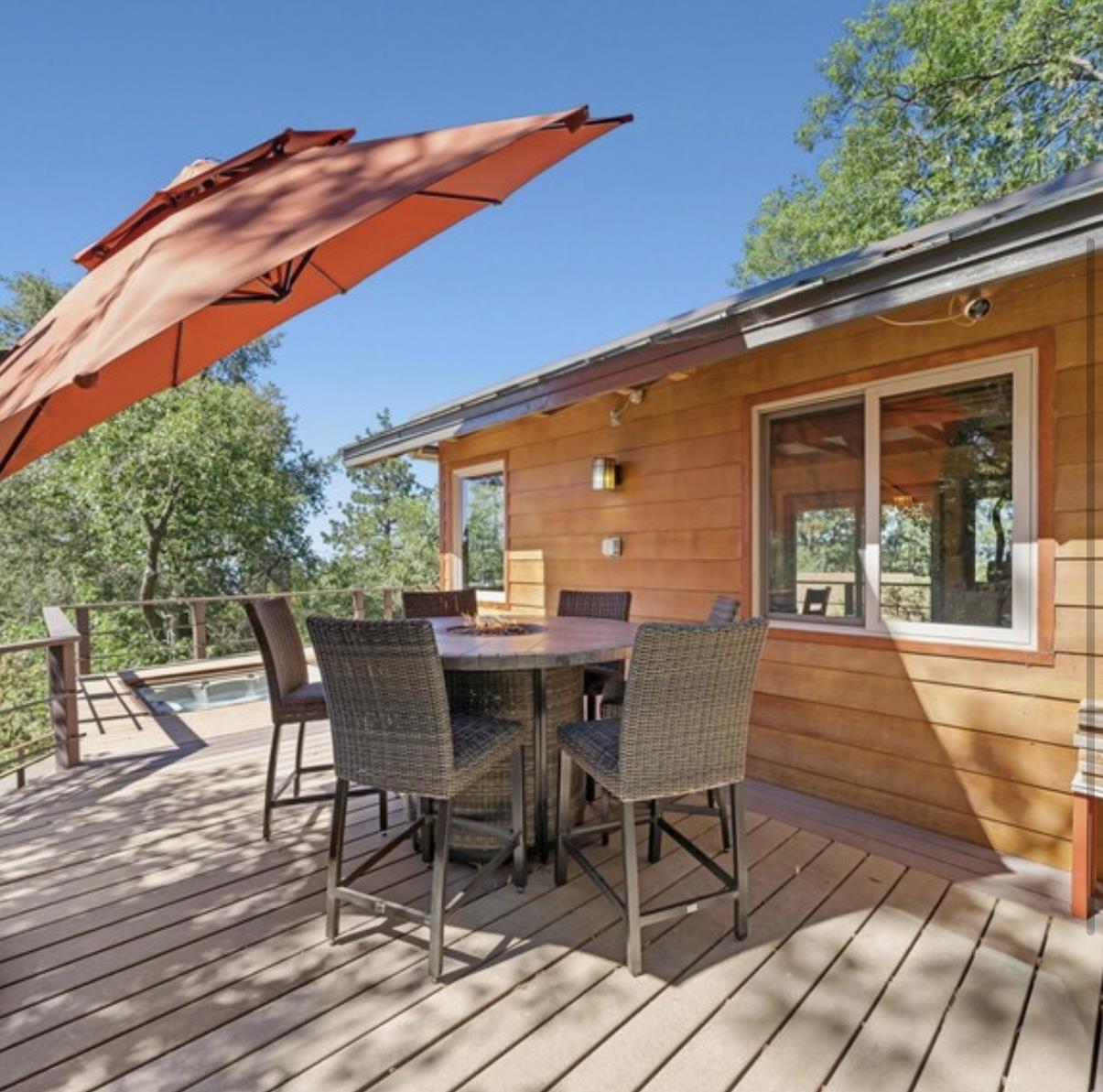 Tabletop firepit located on back deck with seating for six.