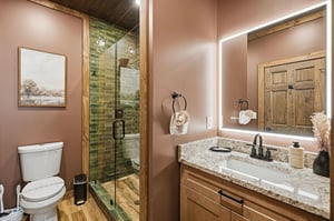 Step into your spalike bathroom with elegant granite counters, rustic wood cabinetry, and a stunning tiled shower that feels like your own private retreat.