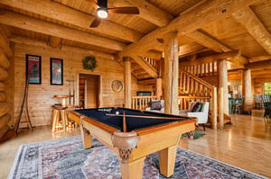 Gather around your own fullsize pool table beneath soaring log beams—a perfect retreat for friendly competition and laughter.