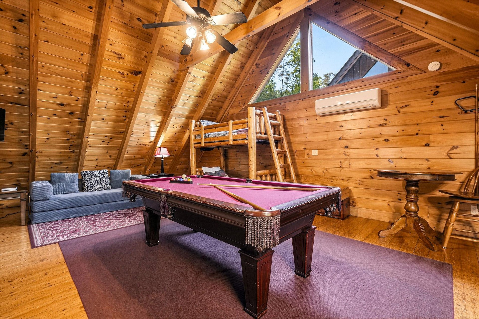 Your rustic game room awaits with a pool table, cozy seating, and charming wooden beams overhead for memorable evenings.