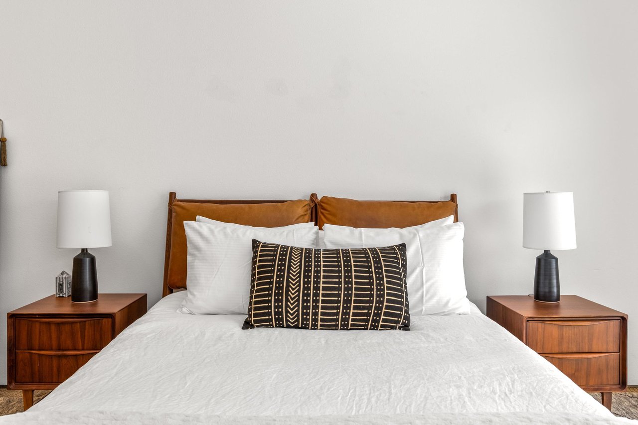 Features a queen bed, sliding doors to poolspa and patio, and ensuite bathroom.