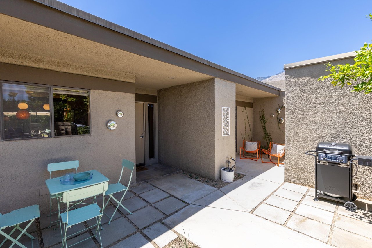 Front patio has additional table and chairs, BBQ, and access to the patio connected to the guest bedroom.