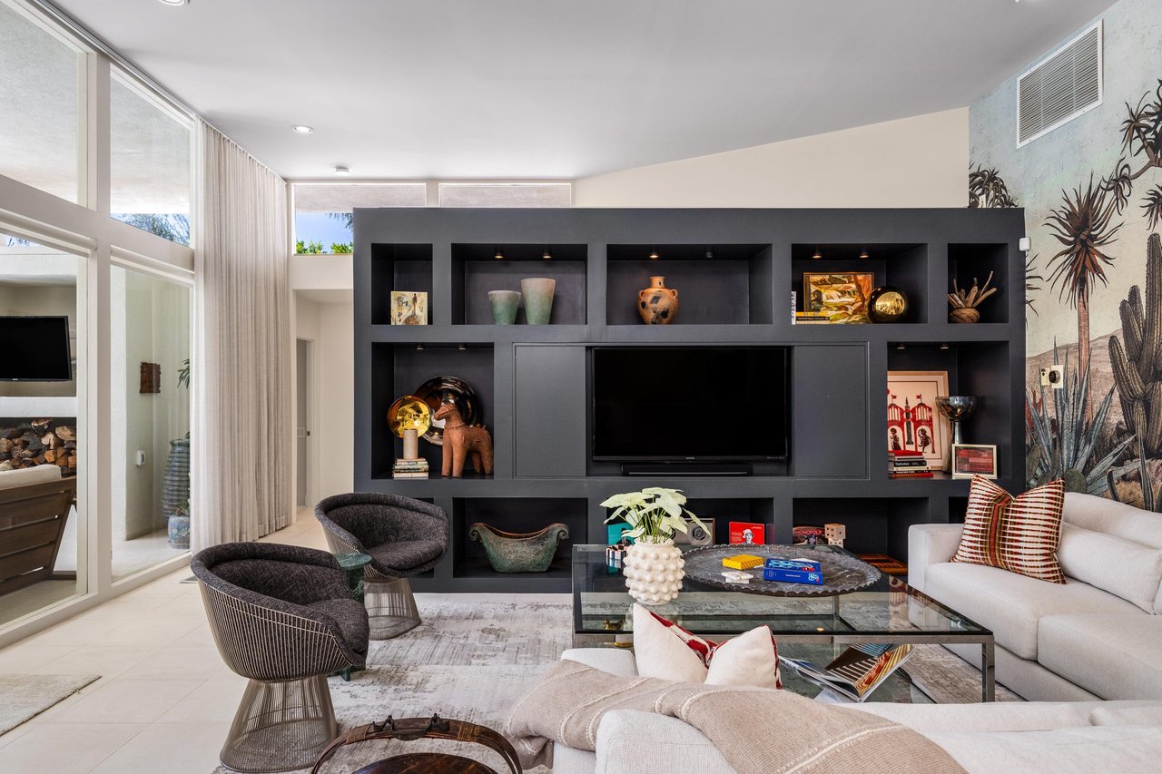 Spacious living room with ample seating and a flatscreen TV with streaming.