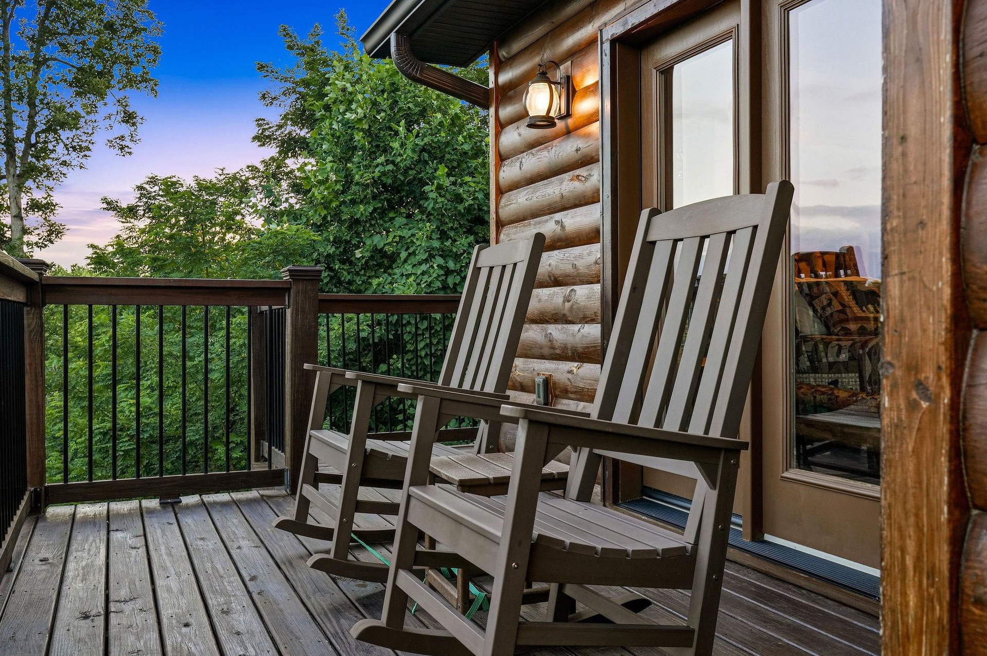 Cabin exterior showcasing its rustic log facade, private deck, and serene forest setting—part of the propertys natural surroundings.
