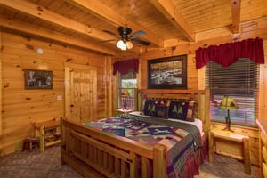 Bedroom with a bed, night stands, and lamps at Graceland, a 4bedroom cabin rental located in Pigeon Forge