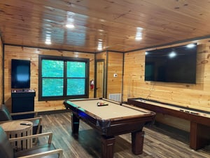 Challenge friends to a game of pool in your private game room, where warm wood paneling and ample seating create the perfect retreat for entertainment and laughter.