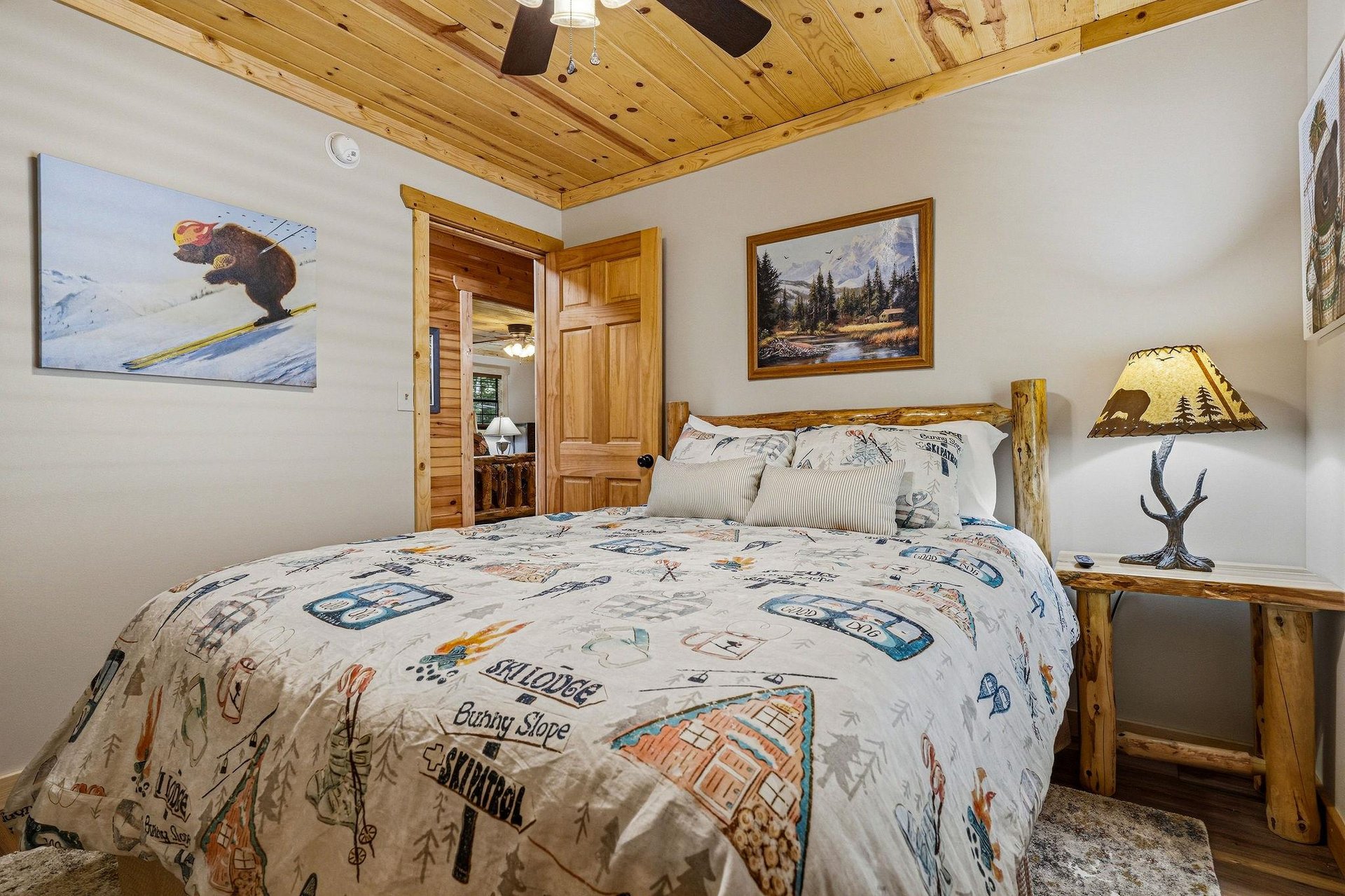 Drift off beneath a gorgeous knotted pine ceiling in your cozy retreat, surrounded by rustic wood accents and charming mountain decor that instantly makes you feel at home.