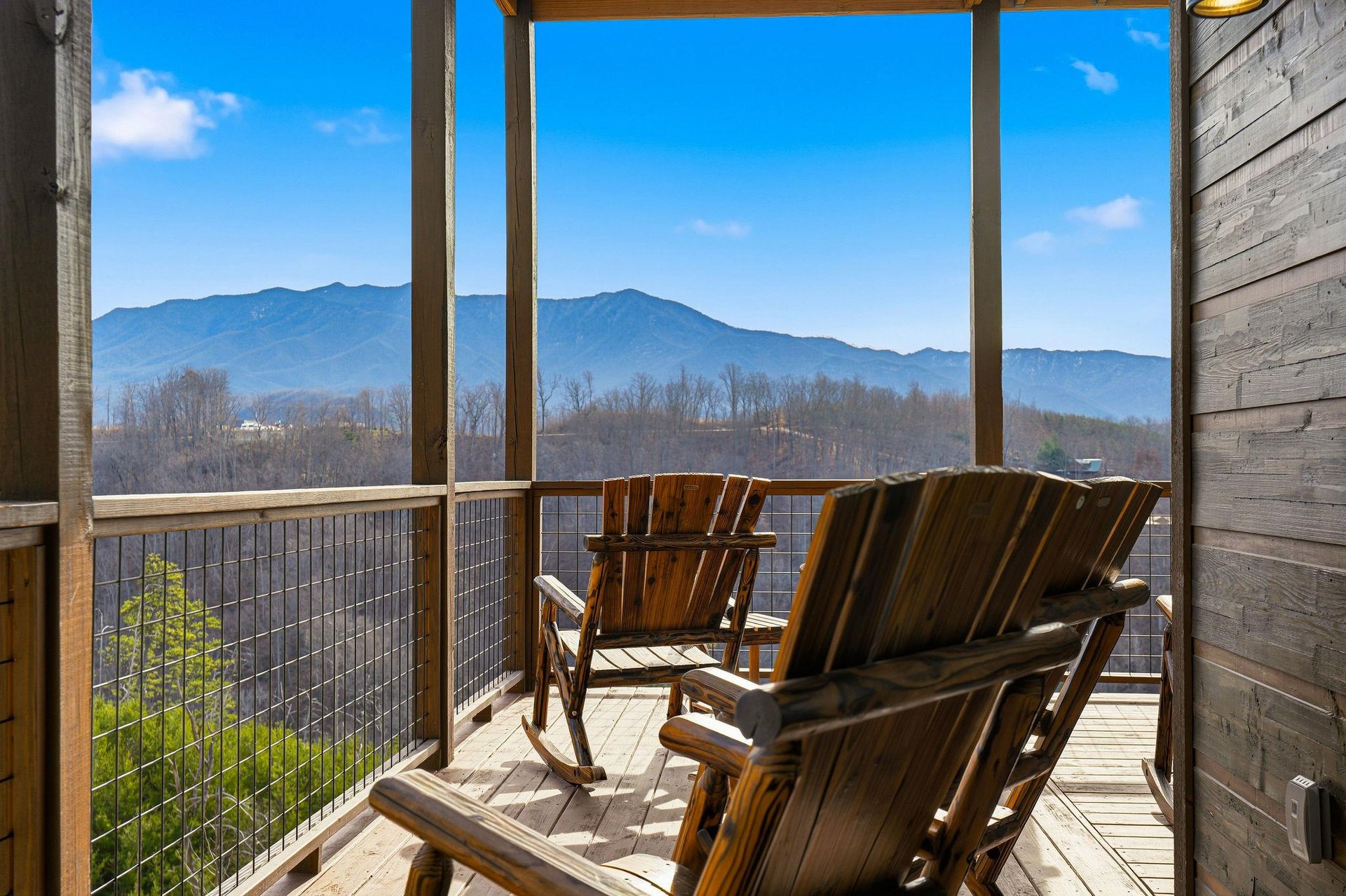 Wake up to breathtaking mountain vistas from your private balcony, where handcrafted wooden chairs invite you to savor morning coffee surrounded by natures grandeur.